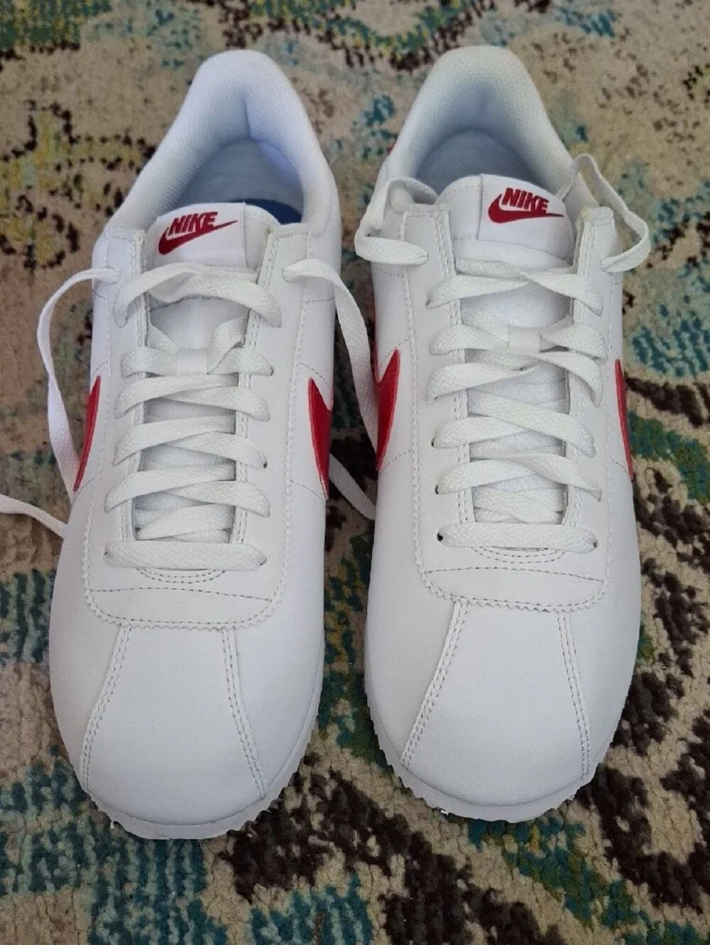 Nike White Sneakers with Red Swoosh and Blue Stripe